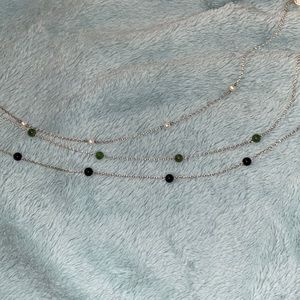 White, green, and black bead necklaces